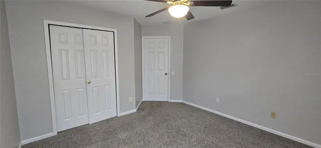 a view of room with a ceiling fan and window