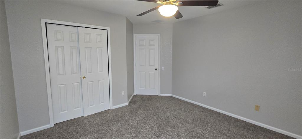 13426 Chariho Lane Windermere, FL 34786 - Photo 14 of 80 an empty room with a chandelier fan