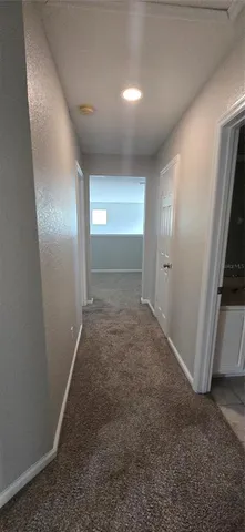 an empty room with a window and a ceiling fan