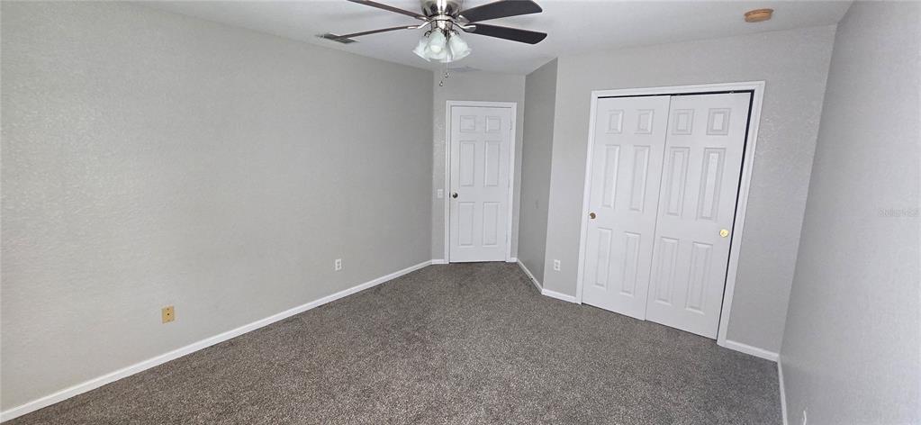 13426 Chariho Lane Windermere, FL 34786 - Photo 19 of 80 an empty room with a ceiling fan and a window