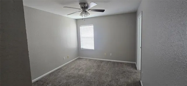 a view of a hallway with wooden floor and entryway
