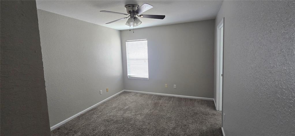 13426 Chariho Lane Windermere, FL 34786 - Photo 24 of 80 a view of room with a ceiling fan and window