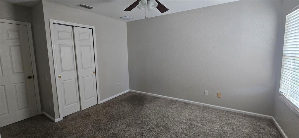 13426 Chariho Lane Windermere, FL 34786 - Photo 28 of 80 an empty room with a window and a ceiling fan