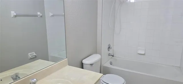 a kitchen with granite countertop a sink a counter top space and cabinets