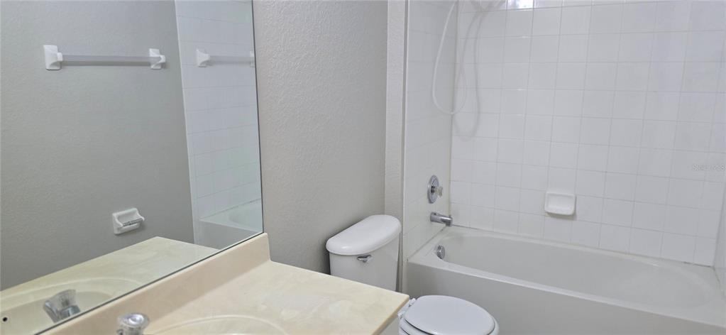 13426 Chariho Lane Windermere, FL 34786 - Photo 38 of 80 a bathroom with a granite countertop toilet a sink and bathtub