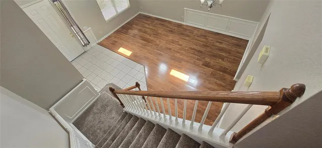 a view of wooden floor and windows in a room