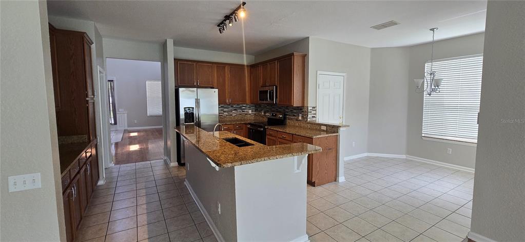13426 Chariho Lane Windermere, FL 34786 - Photo 67 of 80 a kitchen with a stove and a refrigerator
