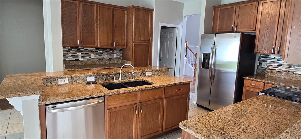 13426 Chariho Lane Windermere, FL 34786 - Photo 69 of 80 a kitchen with stainless steel appliances granite countertop a sink stove and refrigerator