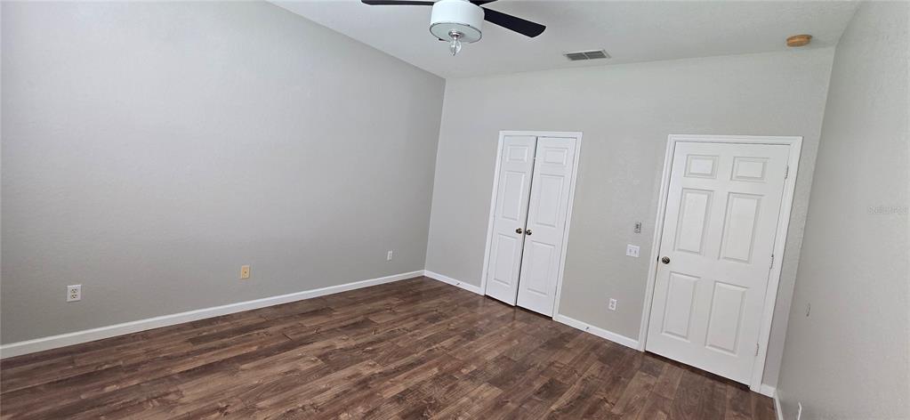 13426 Chariho Lane Windermere, FL 34786 - Photo 76 of 80 a view of room with hardwood floor and a ceiling fan