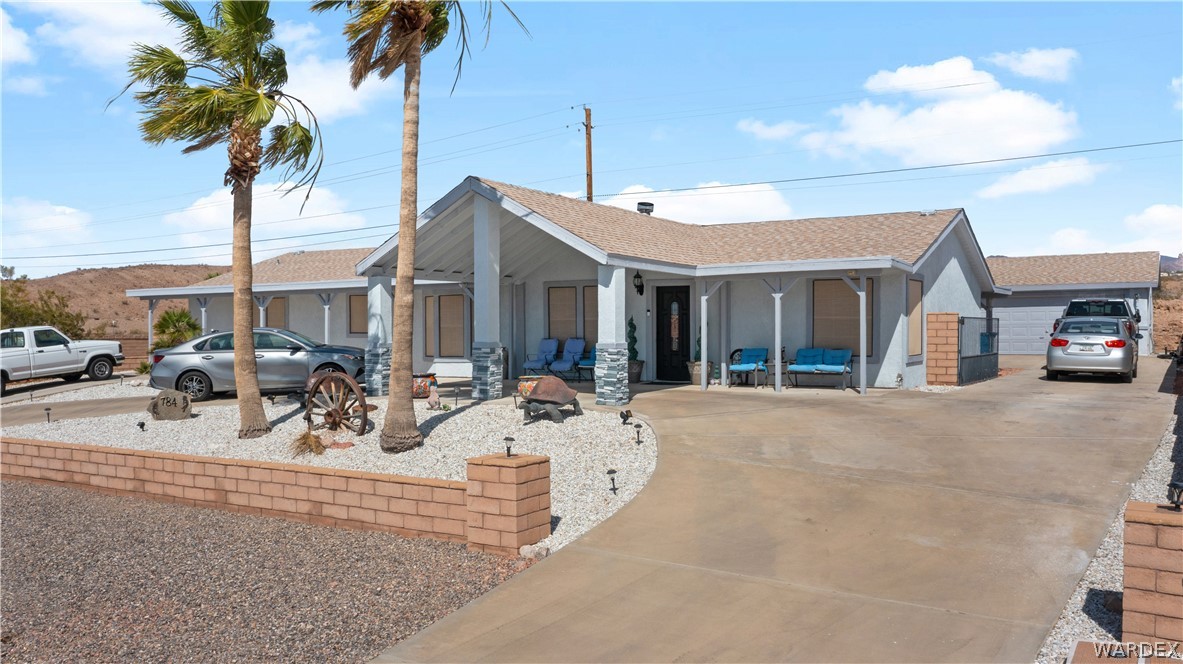 784 Pegasus Ranch Road Bullhead City, AZ 86429 - Photo 86 of 100 Single-story residence featuring a covered entry, stone-clad columns, and a light-toned exterior