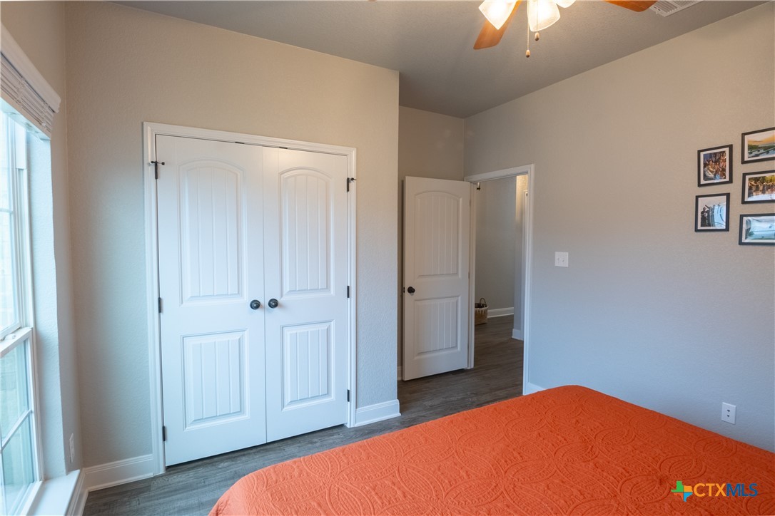 7909 McCulloch Road Temple, TX 76502 - Photo 12 of 46 a bedroom with a bed and a chandelier fan