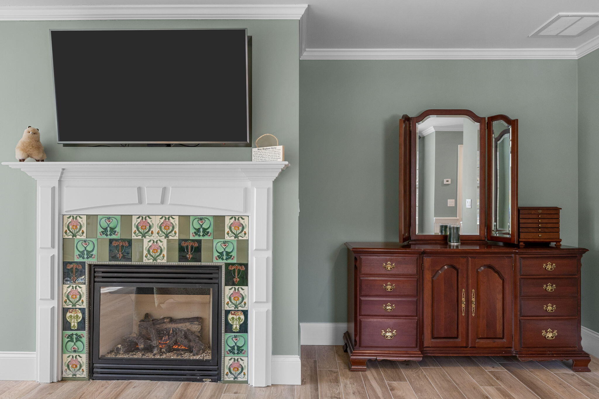 9 Horseshoe Bend Way Mashpee, MA 02649 - Photo 24 of 60 a living room with a fireplace and a flat screen tv