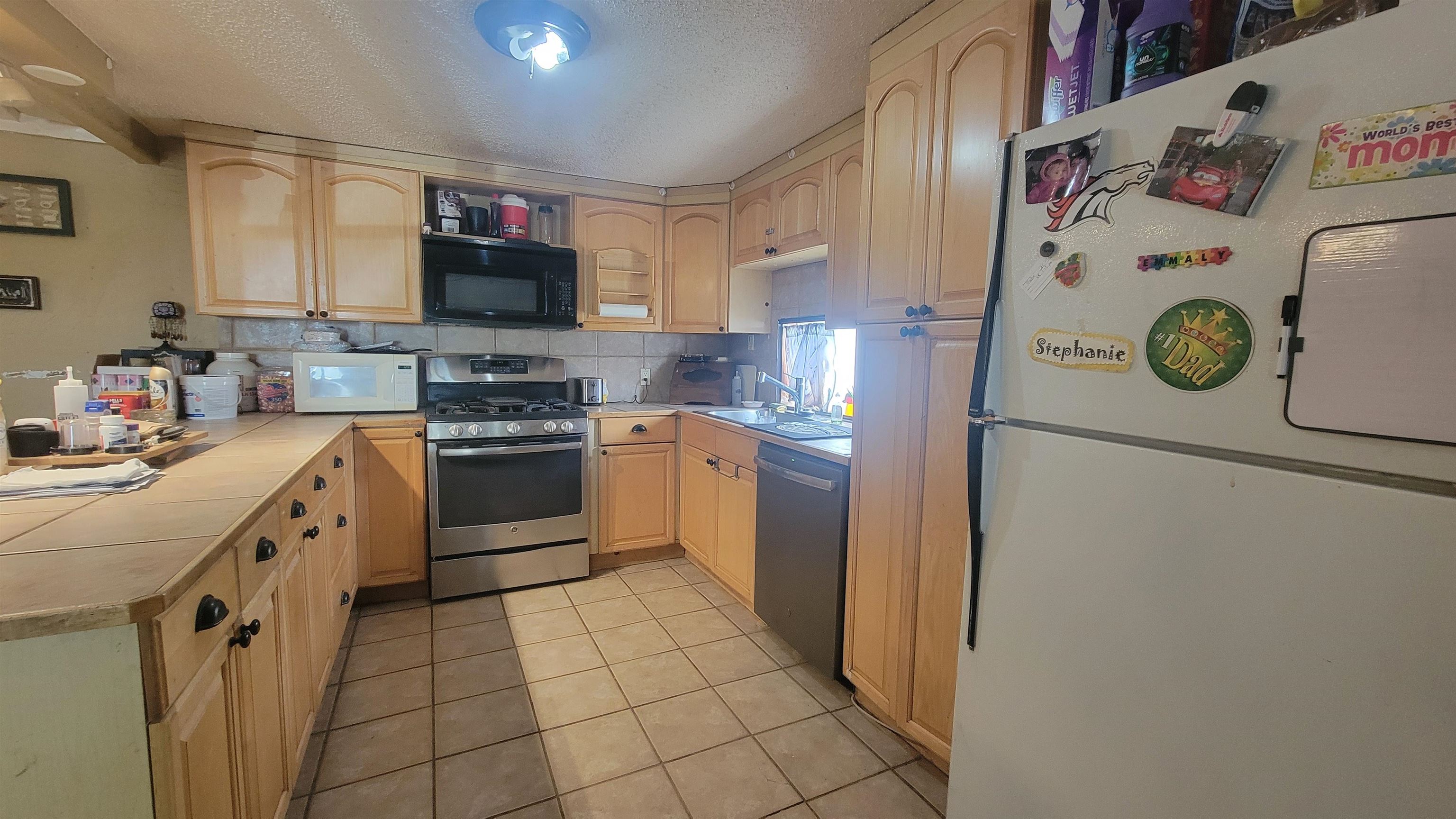 1844 M Road Fruita, CO 81521 - Photo 18 of 32 a kitchen with a white cabinets and white appliances
