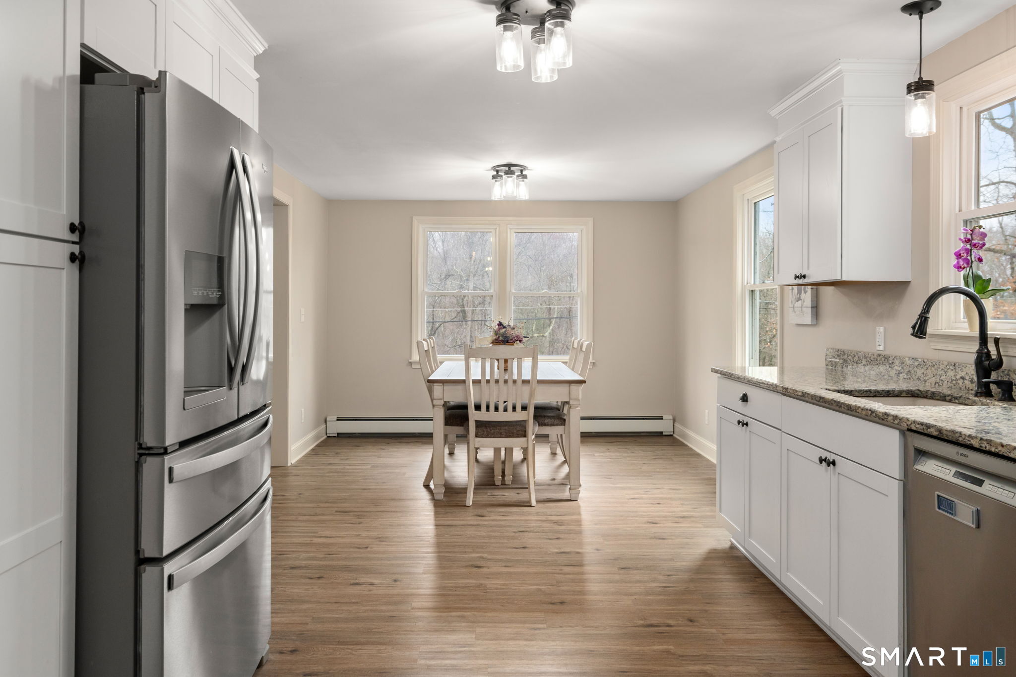 183 Old Hall Road Woodstock, CT 06281 - Photo 13 of 29 a kitchen with a refrigerator a sink cabinets and wooden floor