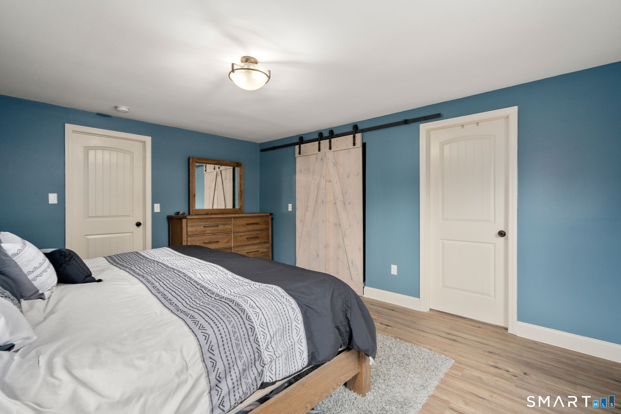 183 Old Hall Road Woodstock, CT 06281 - Photo 23 of 29 a bedroom with a large bed and wooden floor