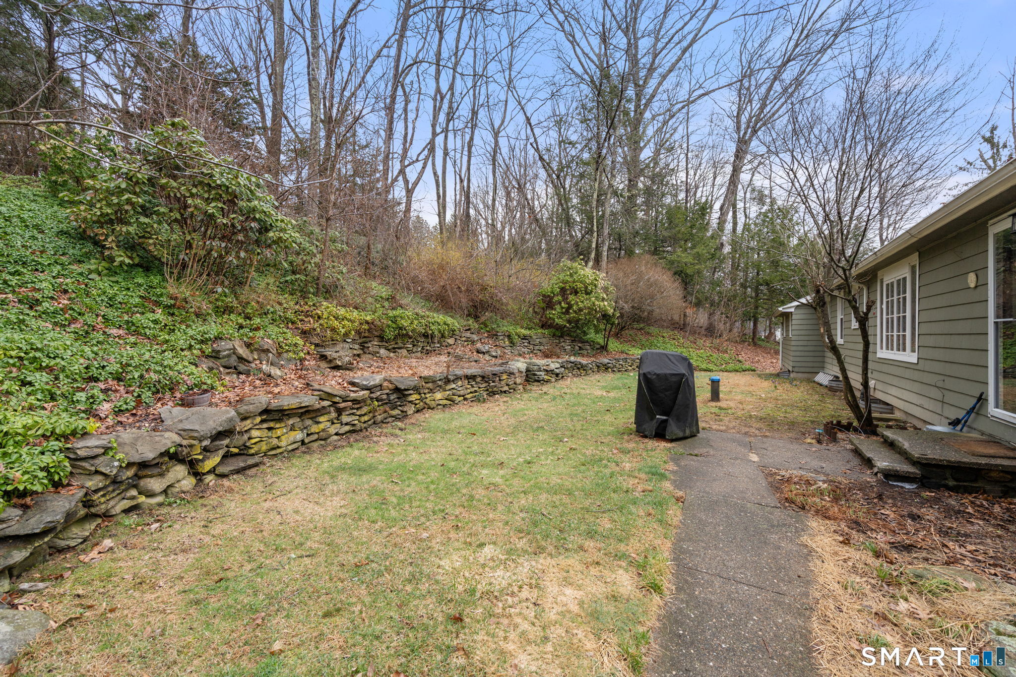 183 Old Hall Road Woodstock, CT 06281 - Photo 4 of 29 a view of a fire pit with large trees
