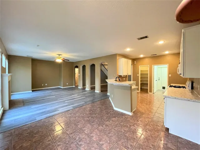 a kitchen with stainless steel appliances granite countertop a stove a sink and a microwave