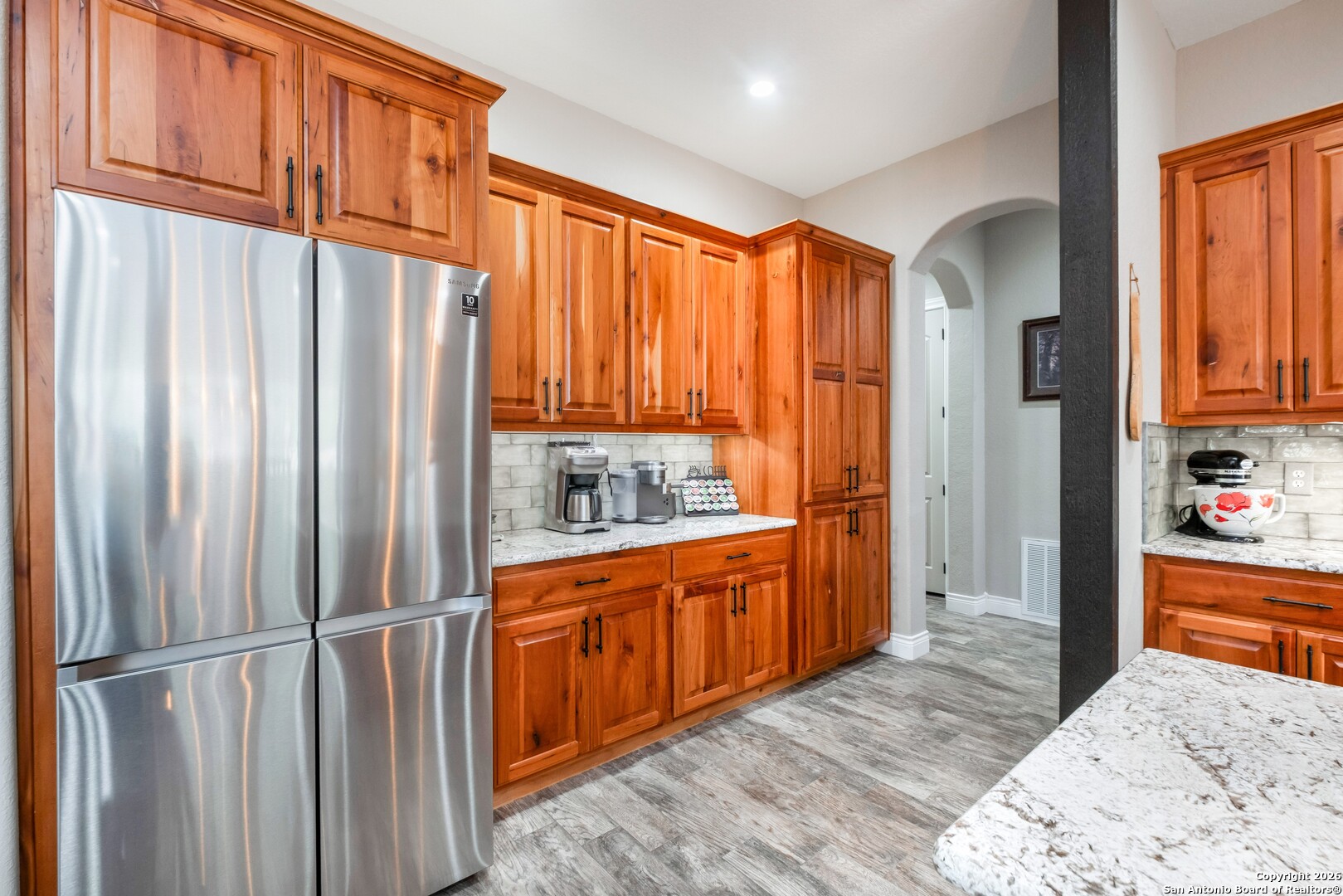 103 Rio Grande Drive Blanco, TX 78606 - Photo 18 of 99 a kitchen with stainless steel appliances granite countertop a refrigerator a sink and dishwasher with wooden floor