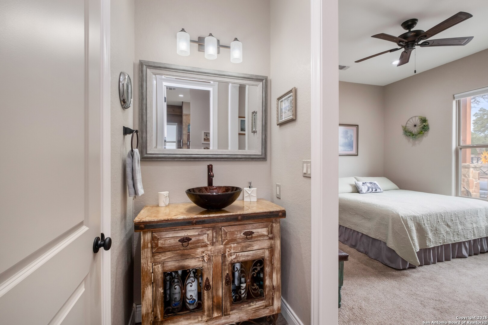 103 Rio Grande Drive Blanco, TX 78606 - Photo 40 of 99 a en suite bathroom with a sink and a mirror