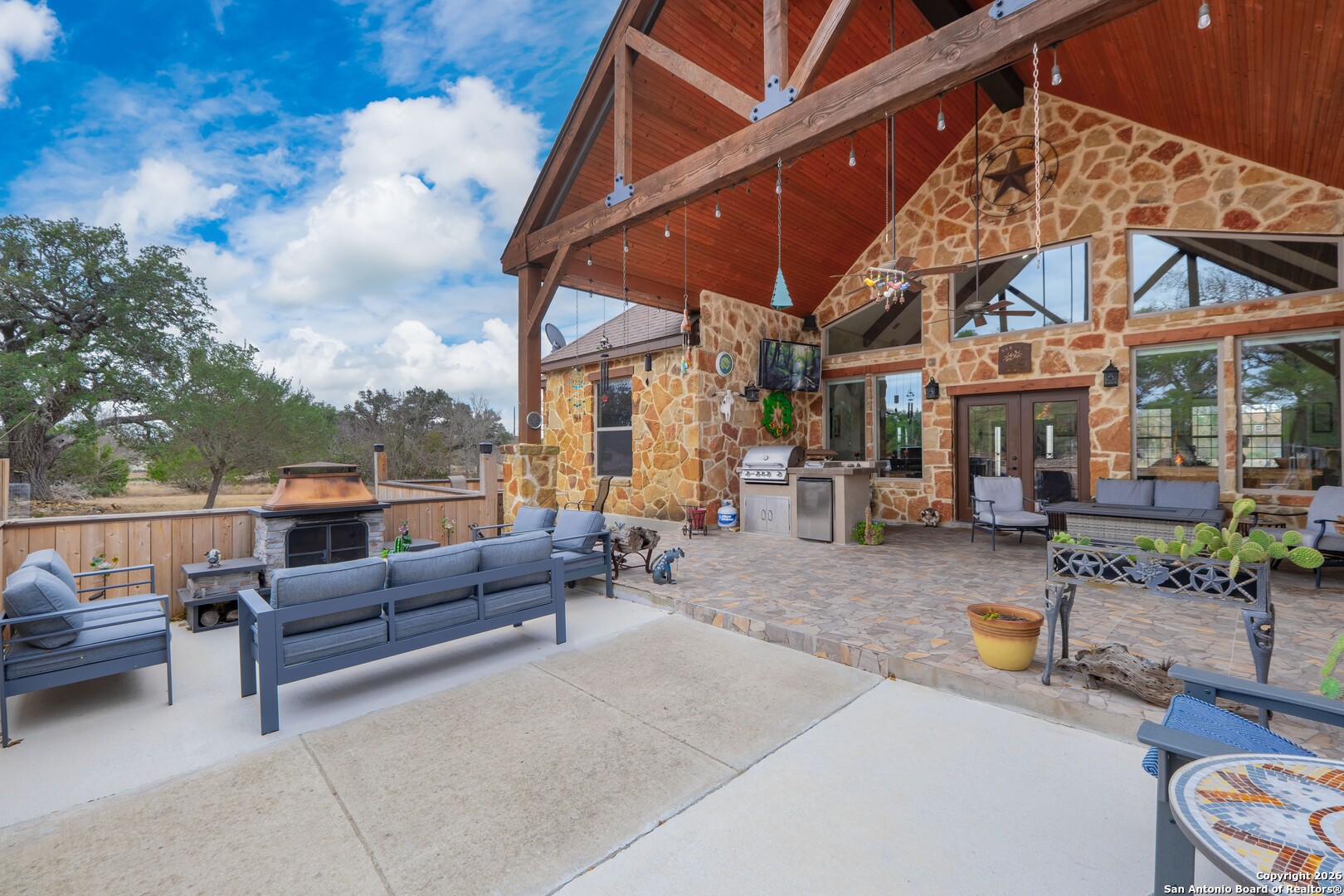 103 Rio Grande Drive Blanco, TX 78606 - Photo 57 of 99 a view of a patio with a table and chairs under an umbrella