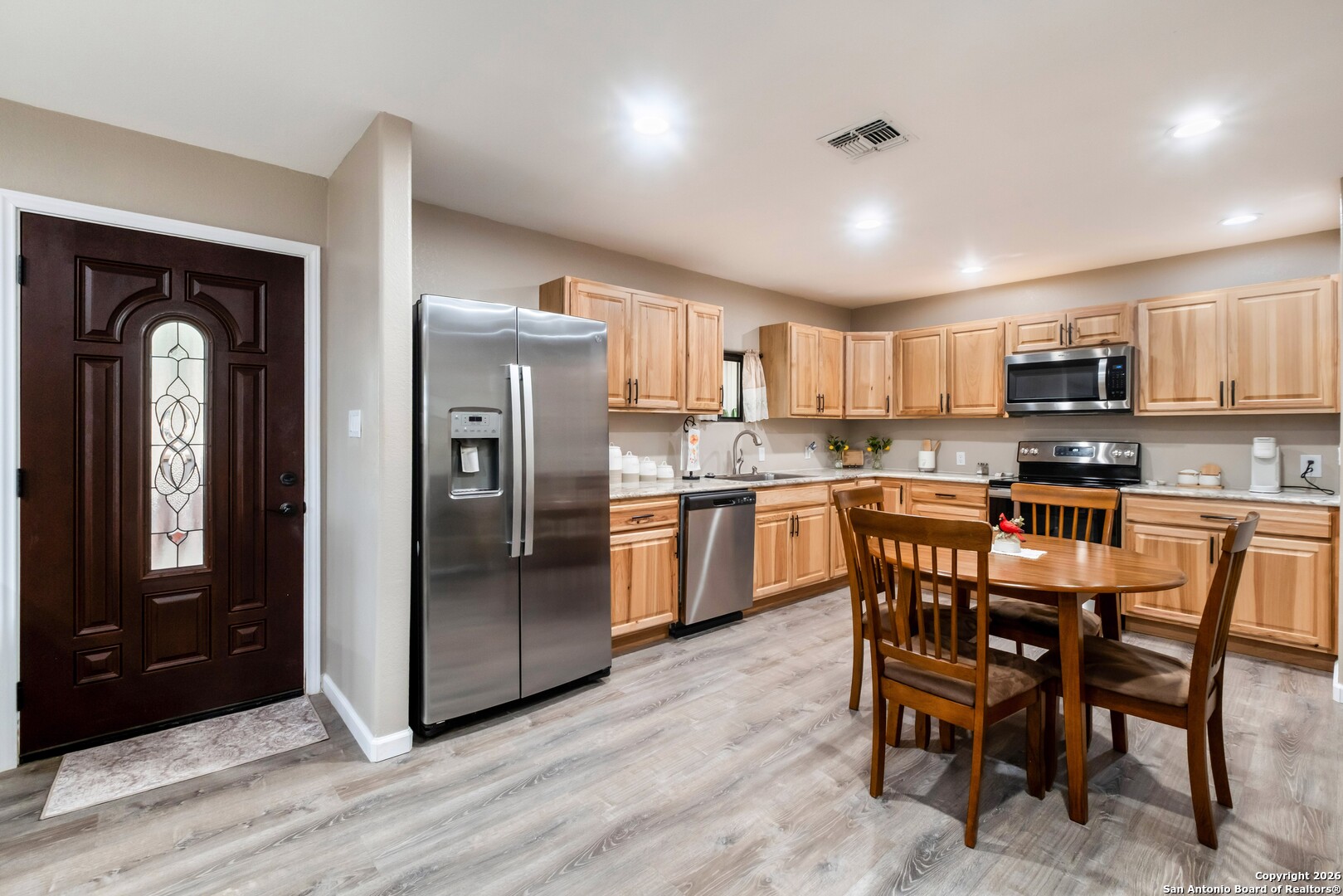 103 Rio Grande Drive Blanco, TX 78606 - Photo 73 of 99 a kitchen with stainless steel appliances granite countertop a refrigerator a sink a stove a microwave and island