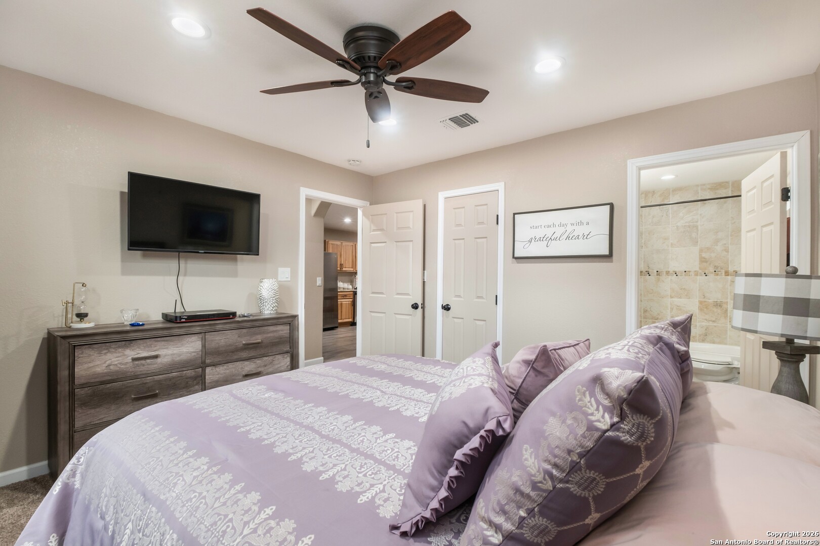 103 Rio Grande Drive Blanco, TX 78606 - Photo 79 of 99 a bedroom with a bed and a flat screen tv