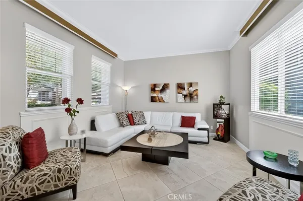 a dining room with furniture a chandelier and wooden floor