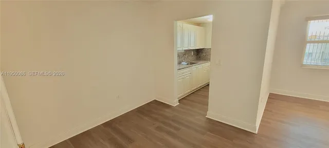 a view of utility room with wooden floor