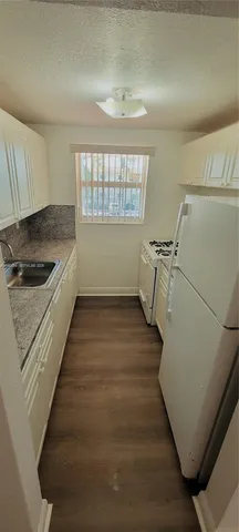 a room with wooden floor and window