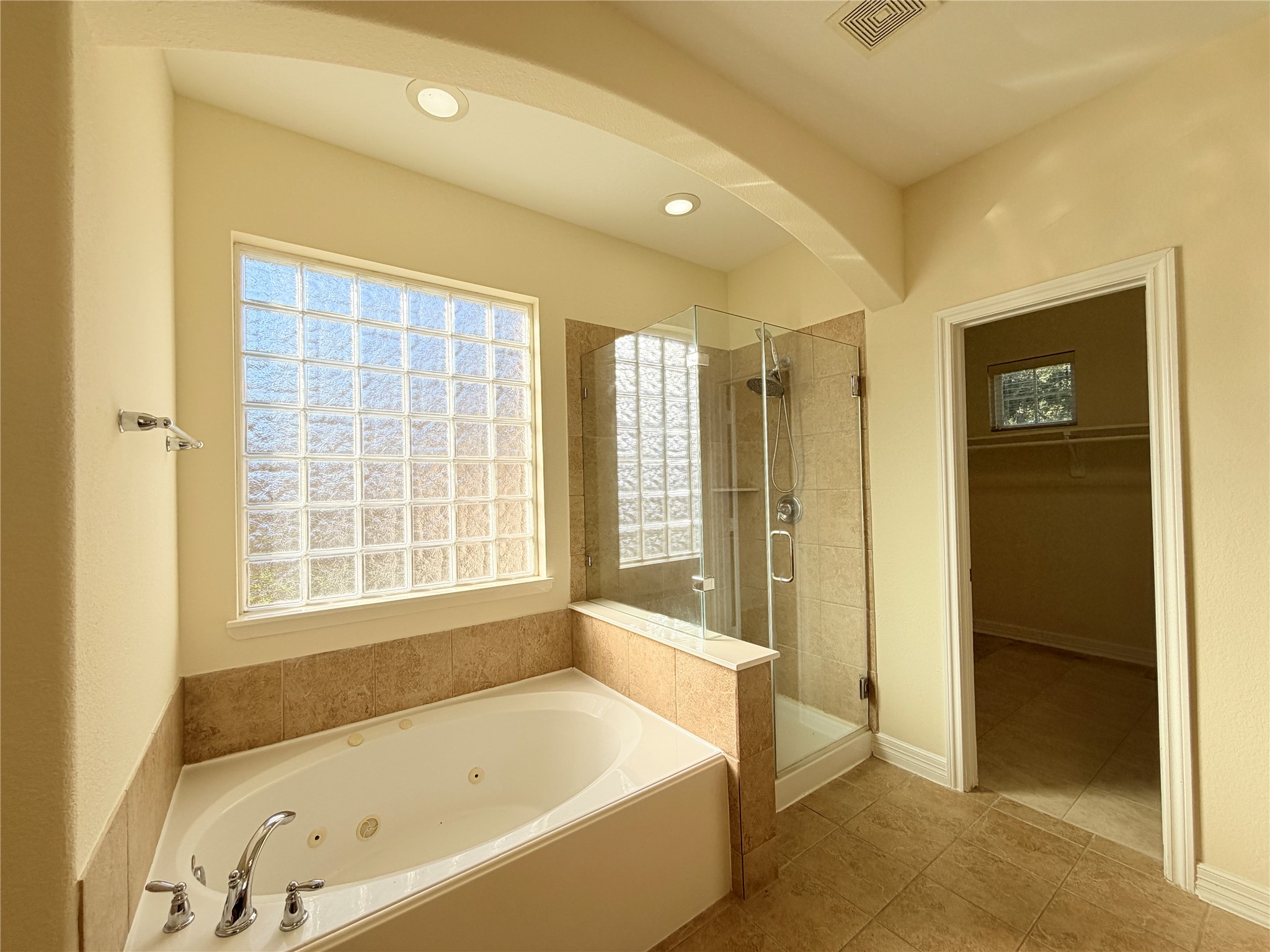 28015 Silverstream Court Fulshear, TX 77441 - Photo 16 of 33 a bathroom with a bathtub and a shower