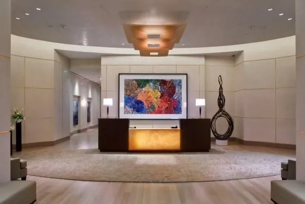 a view of a room with furniture and chandelier