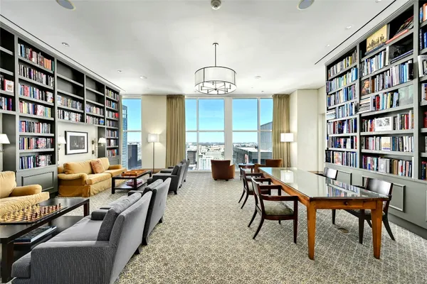 a view of a livingroom with furniture window and wooden floor