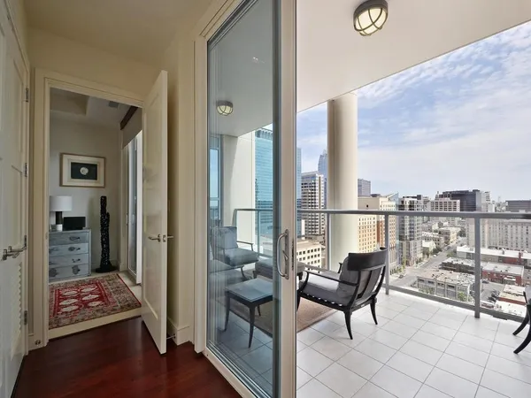 a living room with furniture and a floor to ceiling window