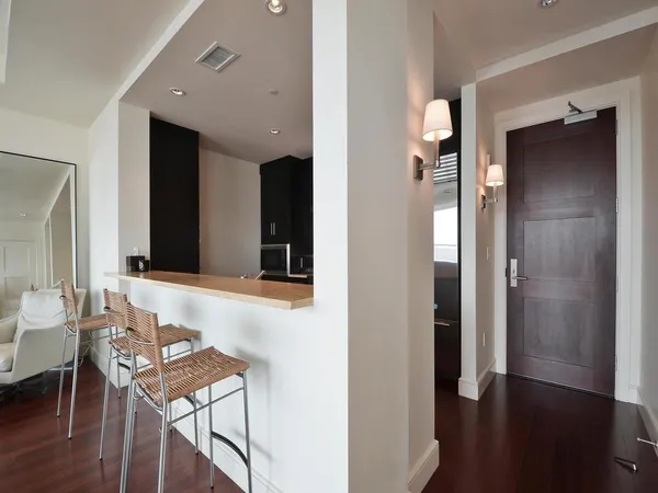a view of a room with furniture and wooden floor