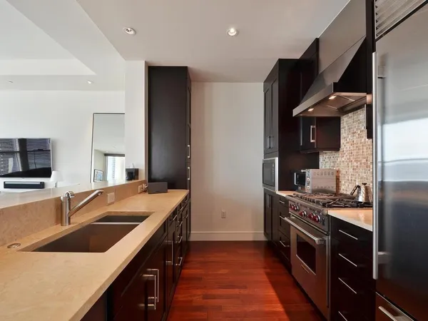 a kitchen that has a sink and a stove