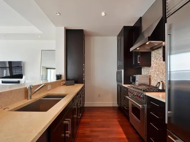 a kitchen that has a sink and a stove