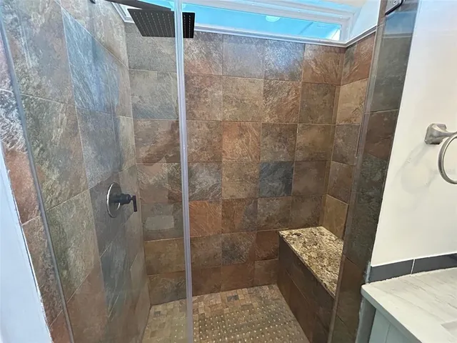 a bathroom with a shower and toilet