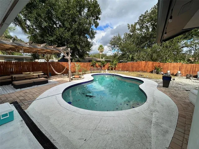 a view of a swimming pool with a patio