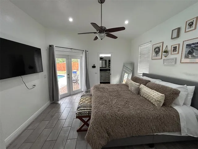 a bedroom with a bed and a flat screen tv