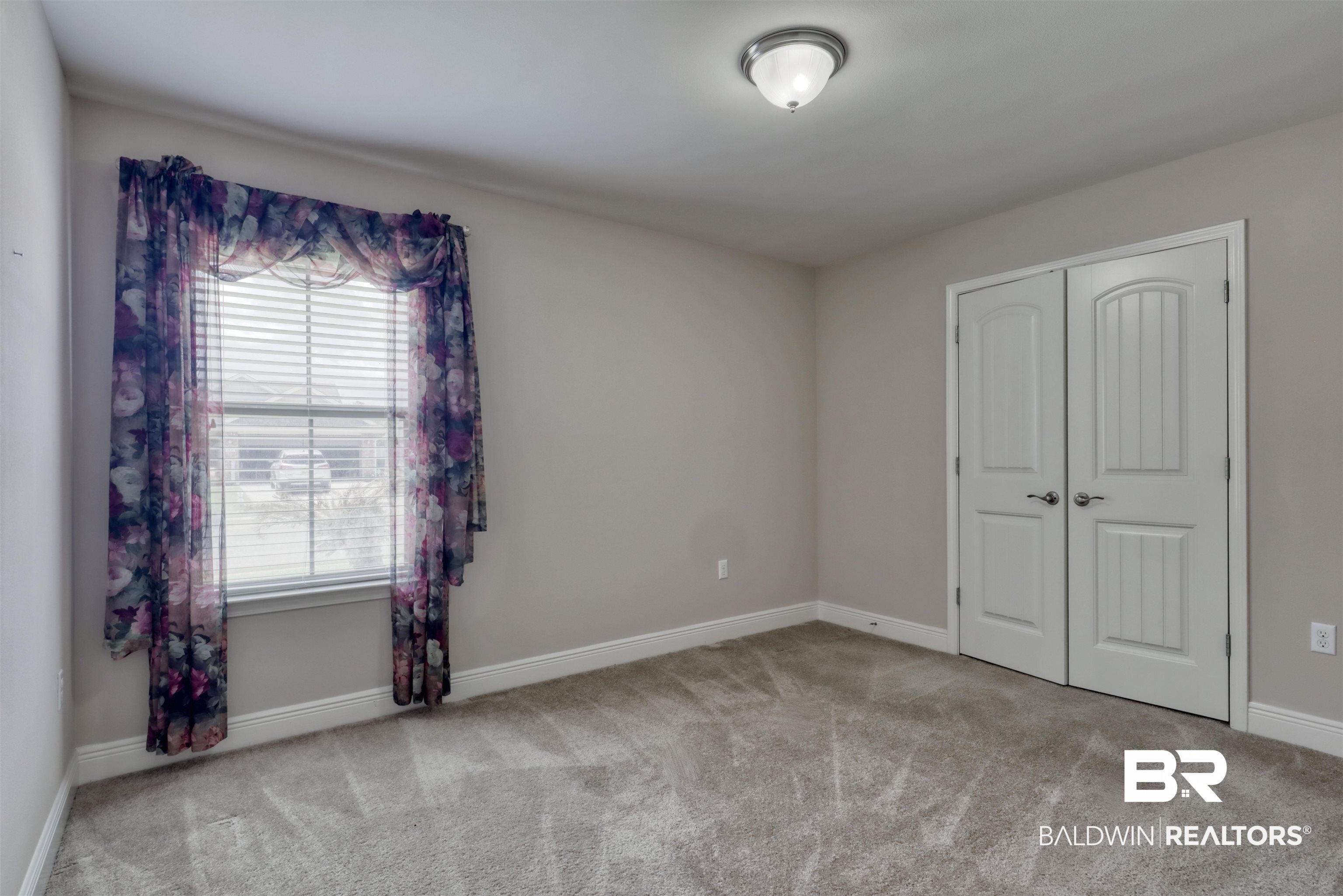 14794 Troon Drive Foley, AL 36535 - Photo 22 of 33 Carpeted spare room with baseboards and a healthy amount of sunlight