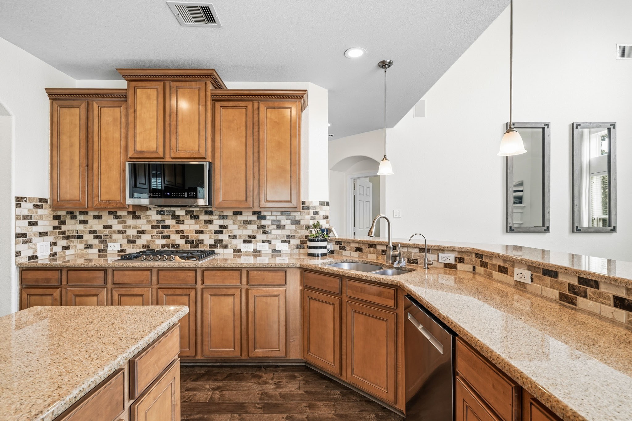17610 Strackfield Lane Tomball, TX 77377 - Photo 14 of 50 A perfect blend of beauty and practicality, this kitchen features granite countertops with decorative tile back splash that elevates the entire space along with plenty of storage space.