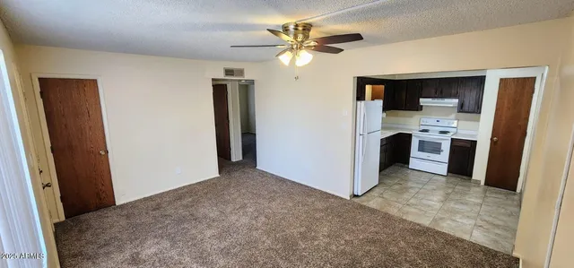 a view of a kitchen with a sink and a refrigerator