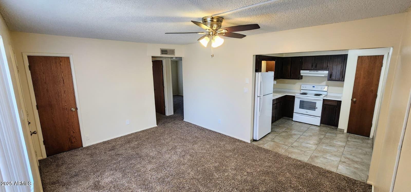 415 East Frost Circle, Unit 419 Mesa, AZ 85203 - Photo 2 of 9 a view of a kitchen with a sink and a refrigerator