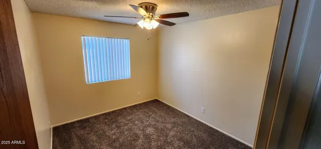 a view of a hallway with a chandelier fan