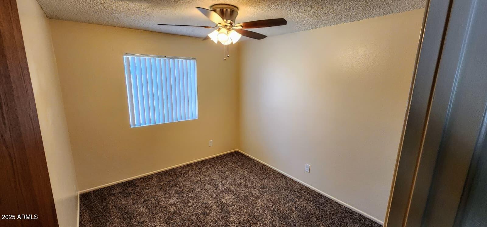 415 East Frost Circle, Unit 419 Mesa, AZ 85203 - Photo 8 of 9 a view of a hallway with a chandelier fan