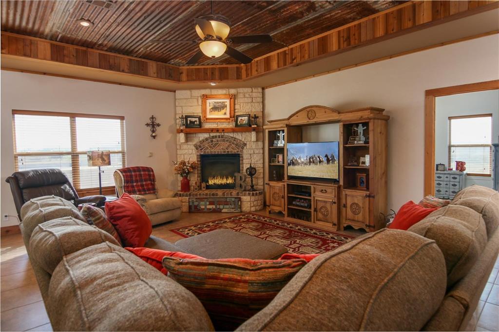 7158 Luella Road Sherman, TX 75090 - Photo 8 of 40 a living room with furniture a fireplace and a flat screen tv