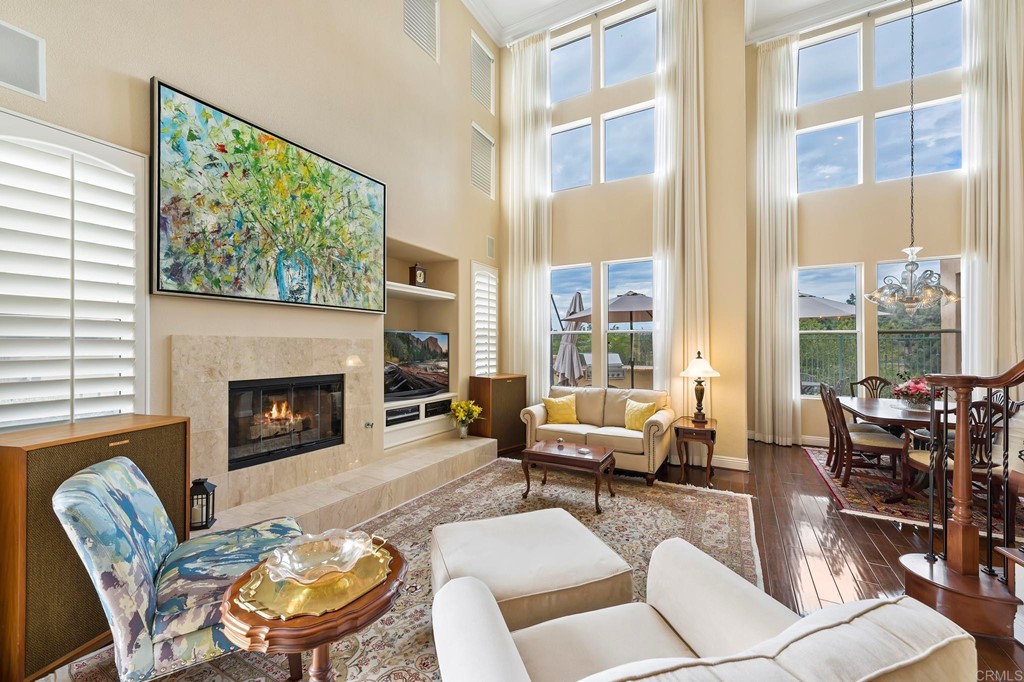 7057 Eider Court Carlsbad, CA 92011 - Photo 11 of 65 a living room with furniture large window and fireplace