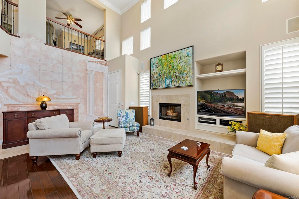 7057 Eider Court Carlsbad, CA 92011 - Photo 12 of 65 a living room with furniture fireplace and flat screen tv