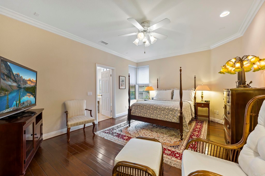 7057 Eider Court Carlsbad, CA 92011 - Photo 28 of 65 a living room with furniture a dining table and a flat screen tv