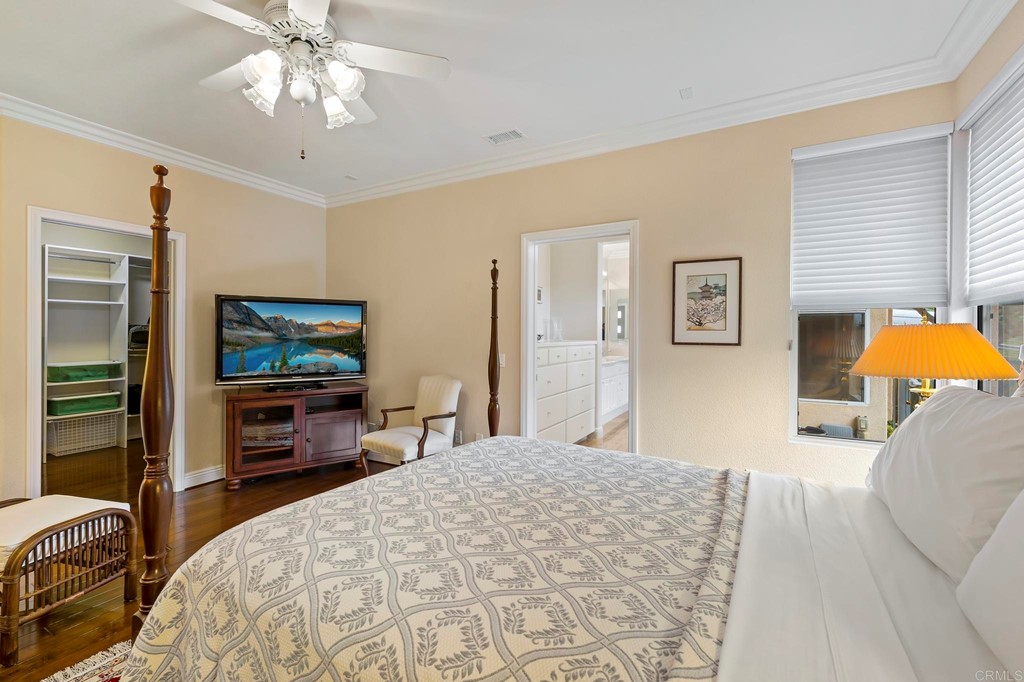 7057 Eider Court Carlsbad, CA 92011 - Photo 30 of 65 a bedroom with a bed and a flat screen tv